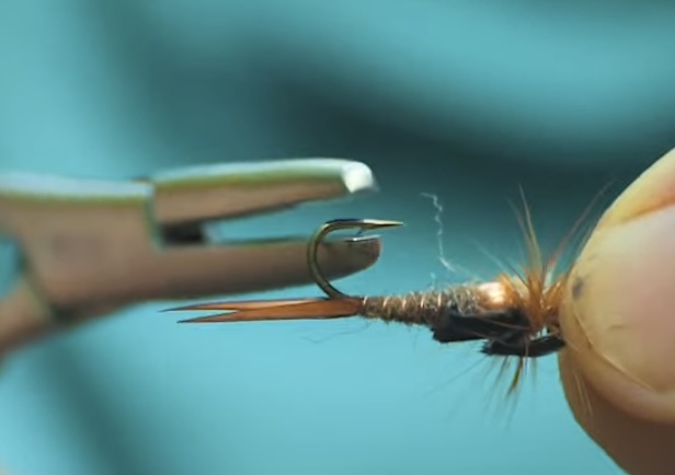 Debarbing a fishing hook